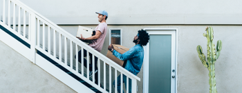 small image of two guys carrying boxes up stairs